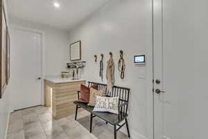 Mudroom featuring recessed lighting and light tile patterned flooring