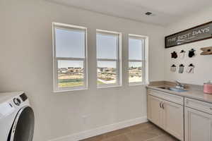 Laundry room featuring washer / dryer and light tile patterned floors