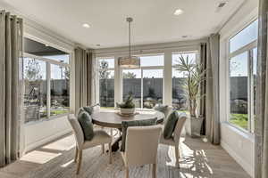 Sunroom / solarium with wood finished floors and recessed lighting