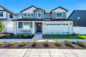 View of front of home with stone siding, board and batten siding, and a porch