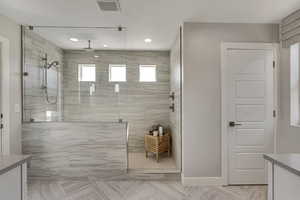 Bath with a walk in shower, and recessed lighting