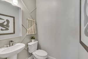 Half bath with toilet and a sink