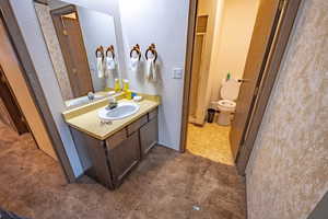 Bathroom with vanity and a textured wall