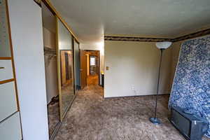 Unfurnished bedroom featuring a closet and carpet flooring