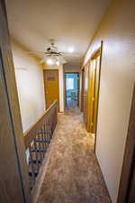 Corridor featuring carpet and an upstairs landing