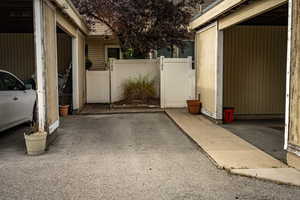 View of side of home featuring a gate