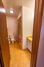 Bathroom featuring vanity, a textured ceiling, and shower / tub combo