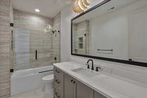 Full bathroom featuring vanity, combined bath / shower with glass door, and recessed lighting