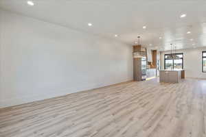 Unfurnished living room with recessed lighting and light wood-style floors