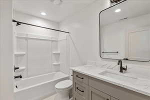 Bathroom featuring shower / bath combination, vanity, and recessed lighting