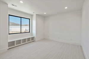 Unfurnished room with light colored carpet, recessed lighting, and a mountain view
