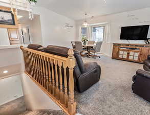 Living area featuring carpet and baseboards