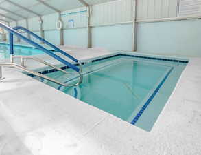 View of swimming pool featuring a jacuzzi and a pool