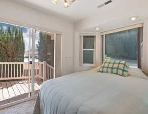 Carpeted bedroom featuring access to outside