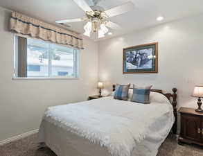 Carpeted bedroom featuring a ceiling fan and recessed lighting