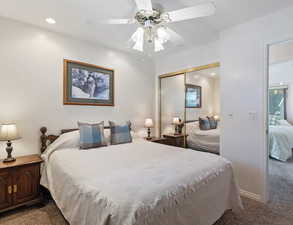 Bedroom featuring dark carpet, recessed lighting, ceiling fan, and a closet