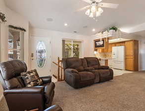 Living area featuring light colored carpet, recessed lighting, and a ceiling fan