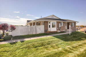 Back of property with brick siding and roof with shingles