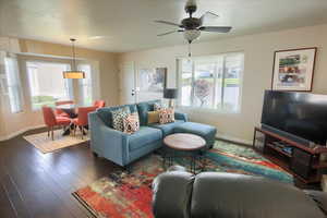Living area featuring wood finished floors and ceiling fan