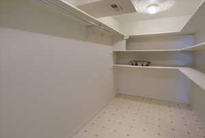 Walk in closet featuring light floors