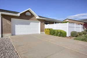 Ranch-style house featuring brick siding, driveway, and a garage