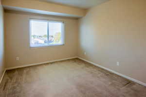 Unfurnished room with baseboards and carpet