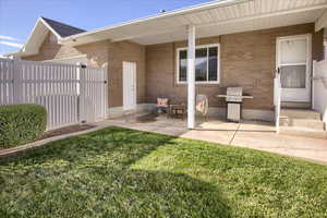 Rear view of property with a porch and brick siding