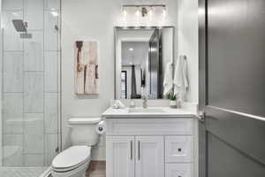 Full bath featuring vanity and a stall shower