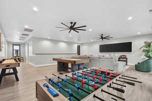 Recreation room with a ceiling fan and recessed lighting