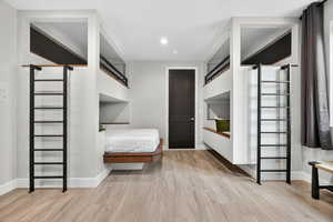 Bedroom with light wood-style floors and recessed lighting