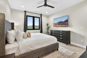 Bedroom featuring light wood-style flooring, ceiling fan, and recessed lighting