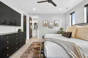 Bedroom with light wood-style floors, recessed lighting, connected bathroom, and ceiling fan
