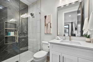 Full bathroom featuring vanity and a marble finish shower
