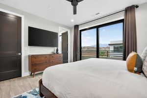 Bedroom with access to exterior, light wood finished floors, ceiling fan, and recessed lighting