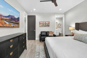 Bedroom featuring recessed lighting, light wood-style floors, a ceiling fan, and ensuite bath