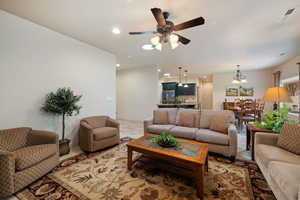 Living area with recessed lighting and a ceiling fan