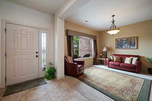 Entrance foyer featuring baseboards and tile patterned floors