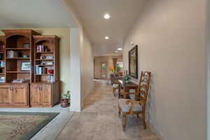 Corridor with recessed lighting, light carpet, and light tile patterned flooring