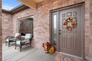 Entrance to property featuring brick siding