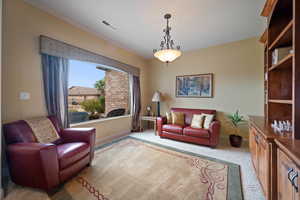 Living area featuring carpet floors and baseboards