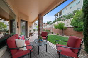 Fenced backyard featuring a patio area and an outdoor hangout area