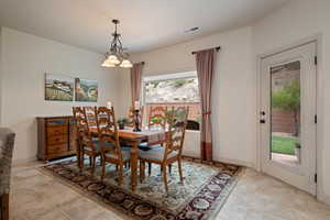 Dining area with a chandelier and baseboards