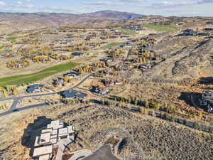 Aerial view of property's location featuring a mountain backdrop and nearby suburban area