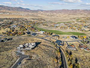 Aerial view of property's location with mountains and nearby suburban area