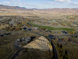 Aerial overview of property's location featuring nearby suburban area and a mountain backdrop