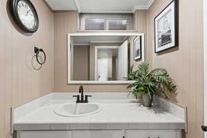 Bathroom with vanity and crown molding