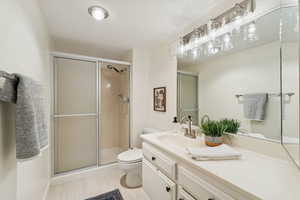 Second guest bathroom with shower and large vanity space.