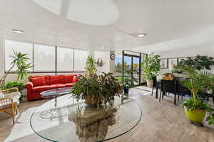 Building lobby featuring a textured ceiling, floor to ceiling windows, and recessed lighting