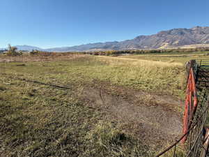 View of mountain backdrop featuring rural landscape