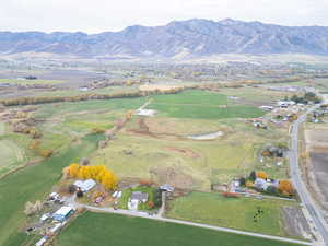 Aerial view of property and surrounding area with a mountainous background
